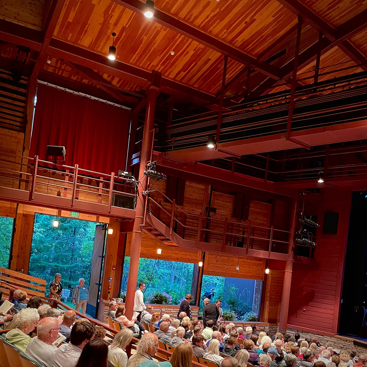 Inside the Peninsula Players Theater with the doors and walls open to the surrounding forest.