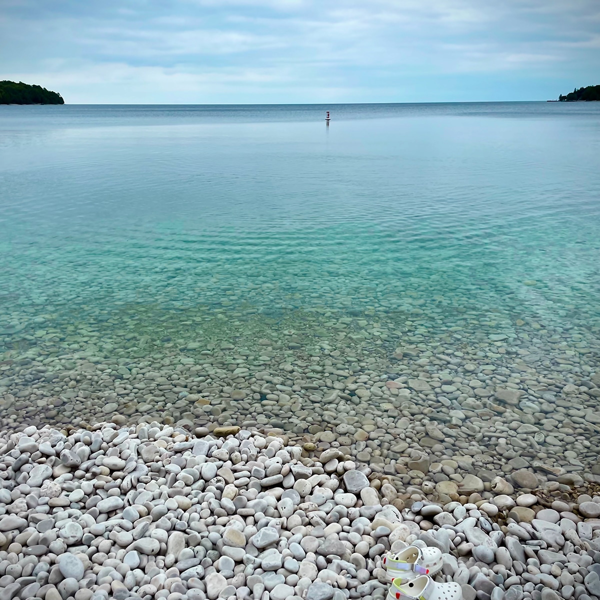 The smooth rocks and clear waters of Schoolhouse beach on Washington Island.