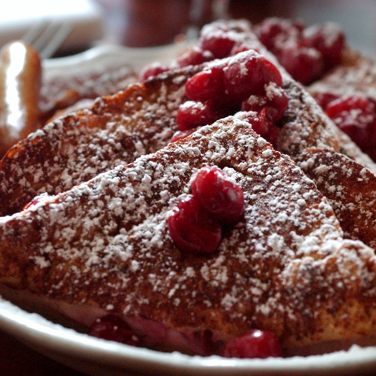 A plate of cherry stuffed french toast.