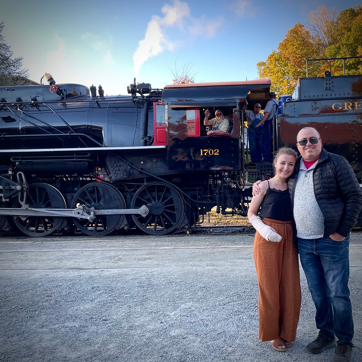 Steve and Annie standing in front of the Great Smoky Mountain Railroad steam engine.