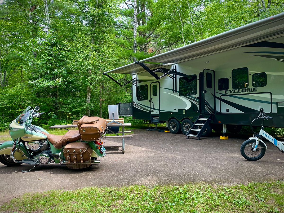 Our RV and Motorcycle parked in a campground in northern Wisconsin.