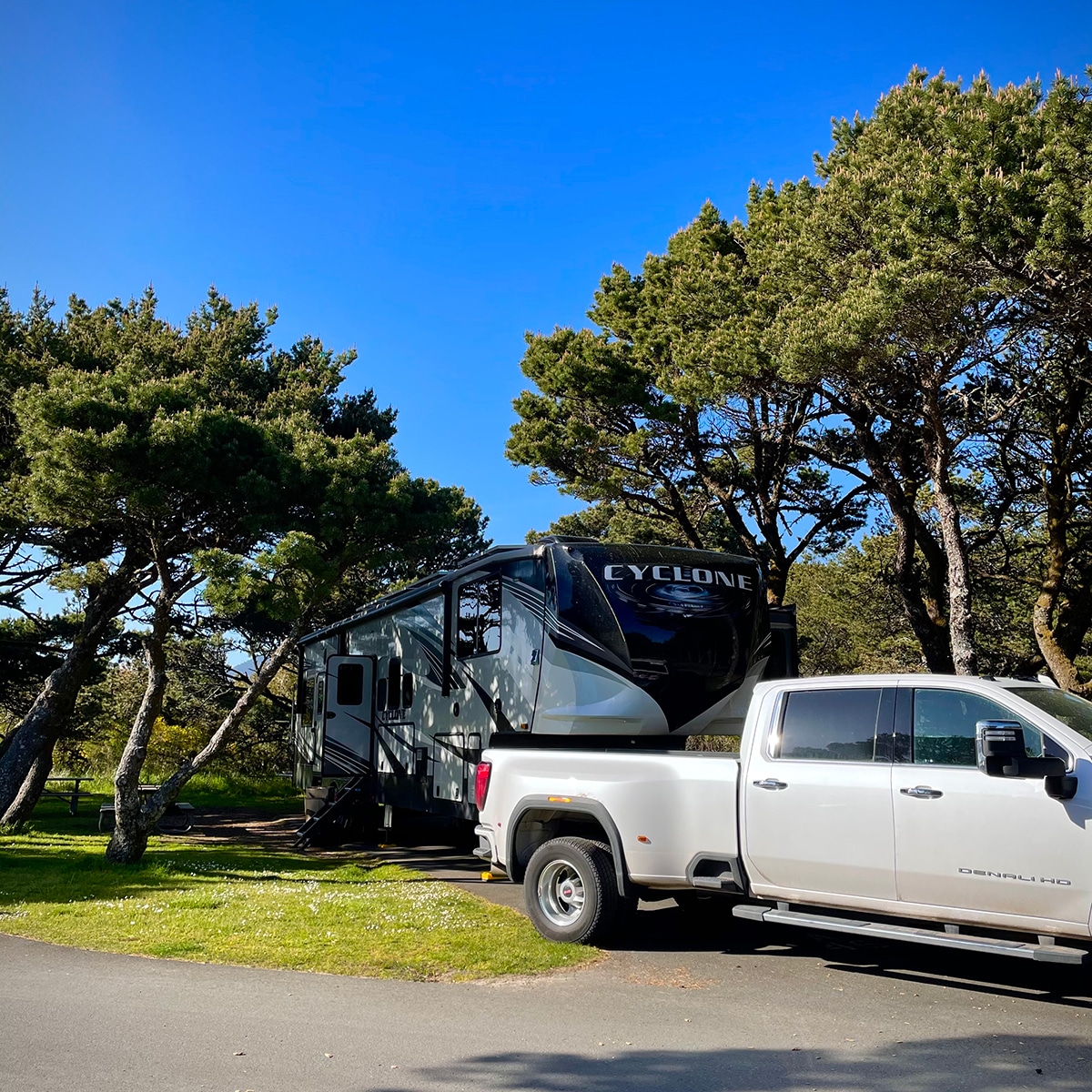 Our 5th wheel RV and truck parked in a space in Nehalem Bay State Park in Oregon.