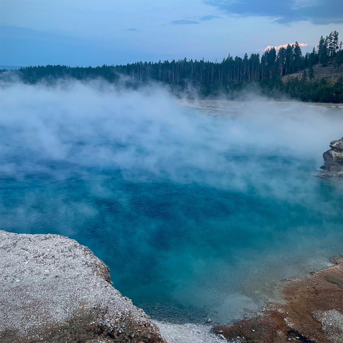 Steam rising from the water at a hot springs in Yellowstone National Park.