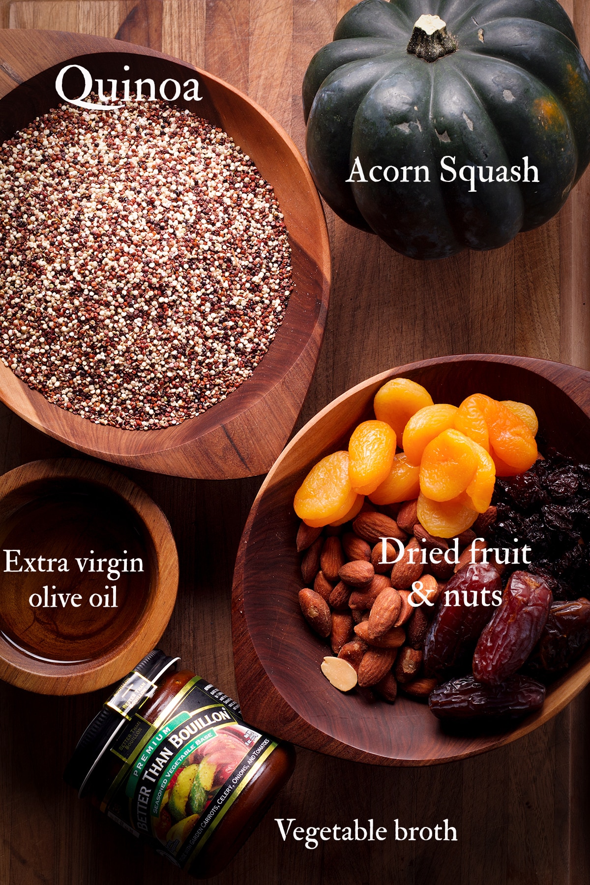 All the ingredients you need to make vegan quinoa stuffed acorn squash displayed on a cutting board.