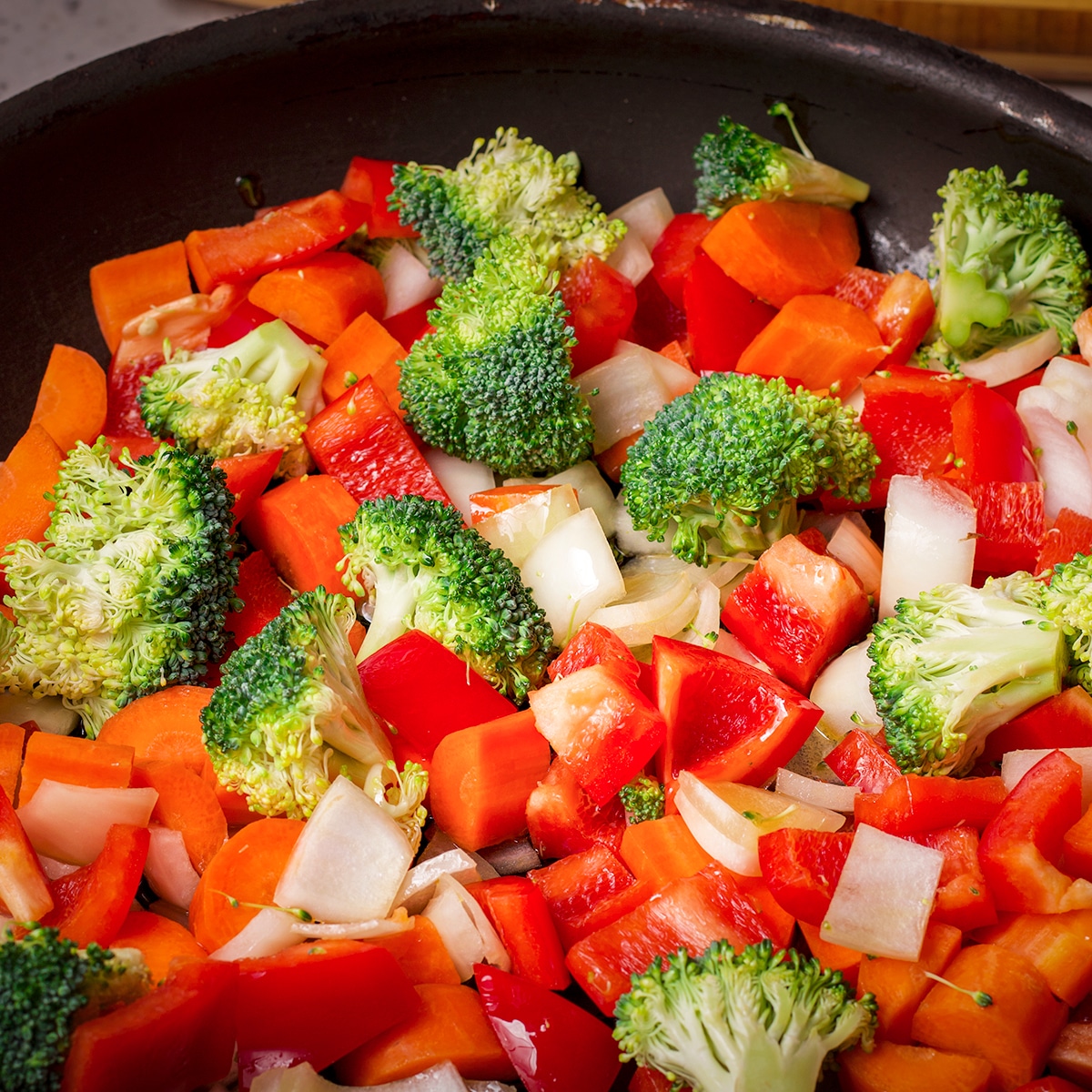 Chopped vegetables in a skillet.
