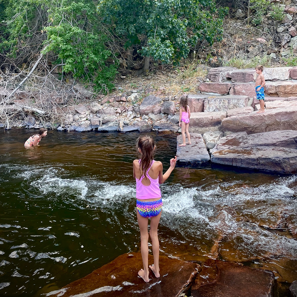 Children playing in the river at LaVern M Johnson park in Lyons, Colorado.