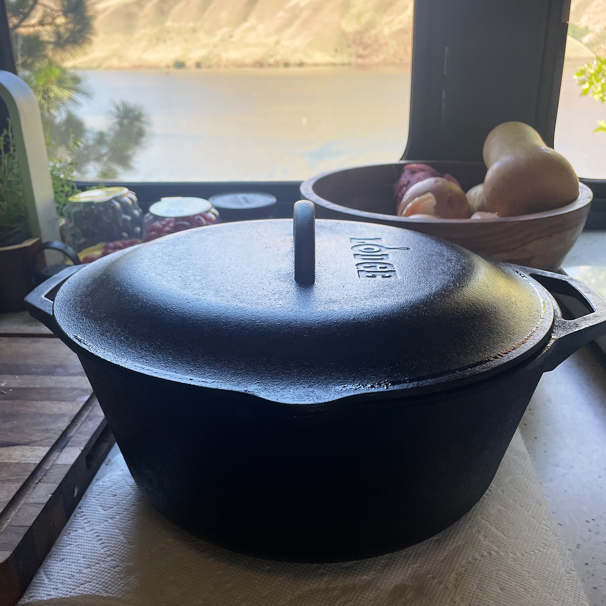 A cast iron Dutch oven resting on pieces of tofu to squeeze excess water from the tofu,
