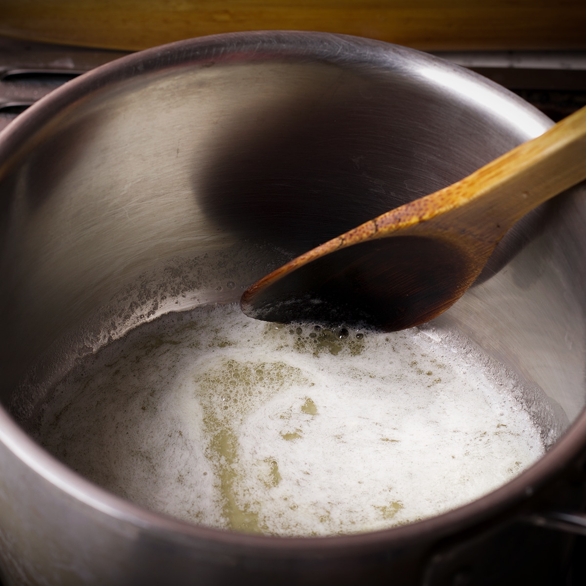 Melting butter in a saucepan on the stovetop.