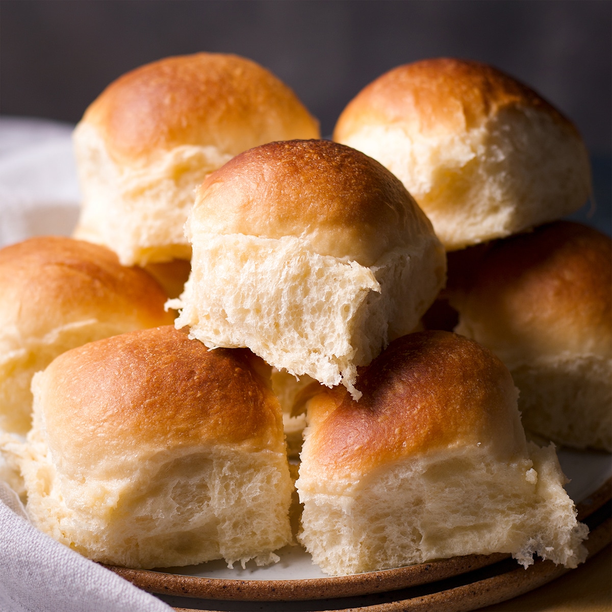A plate piled high with homemade dinner rolls.