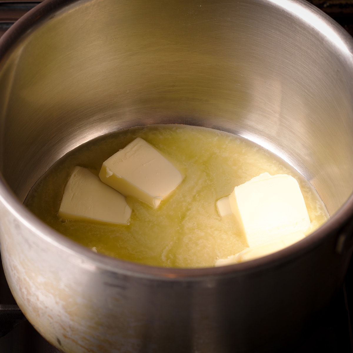 Pieces of butter melting in a saucepan.