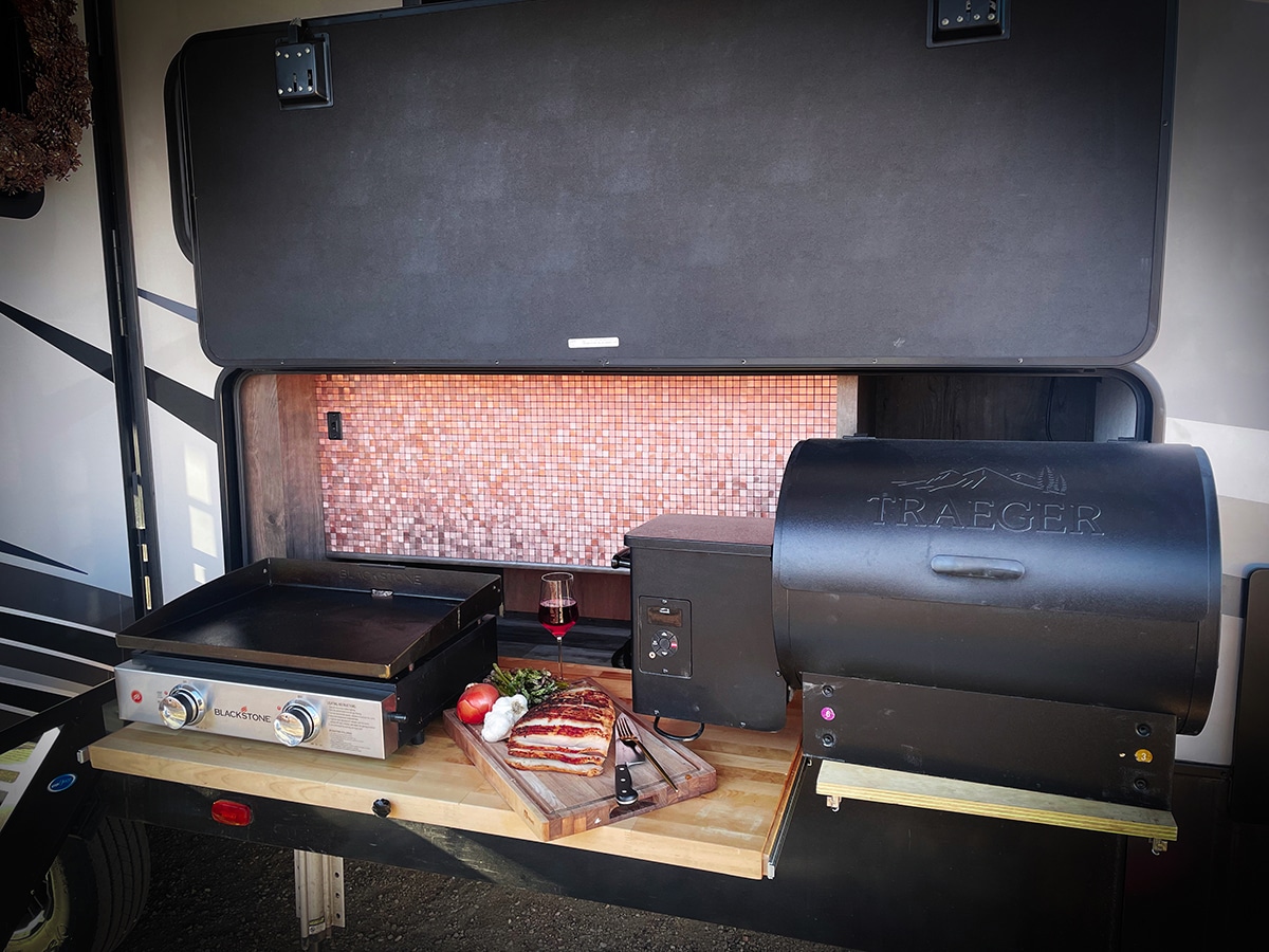 The remodeled outdoor kitchen in our 5th wheel RV that includes a Blackstone griddle and Traeger Grill.