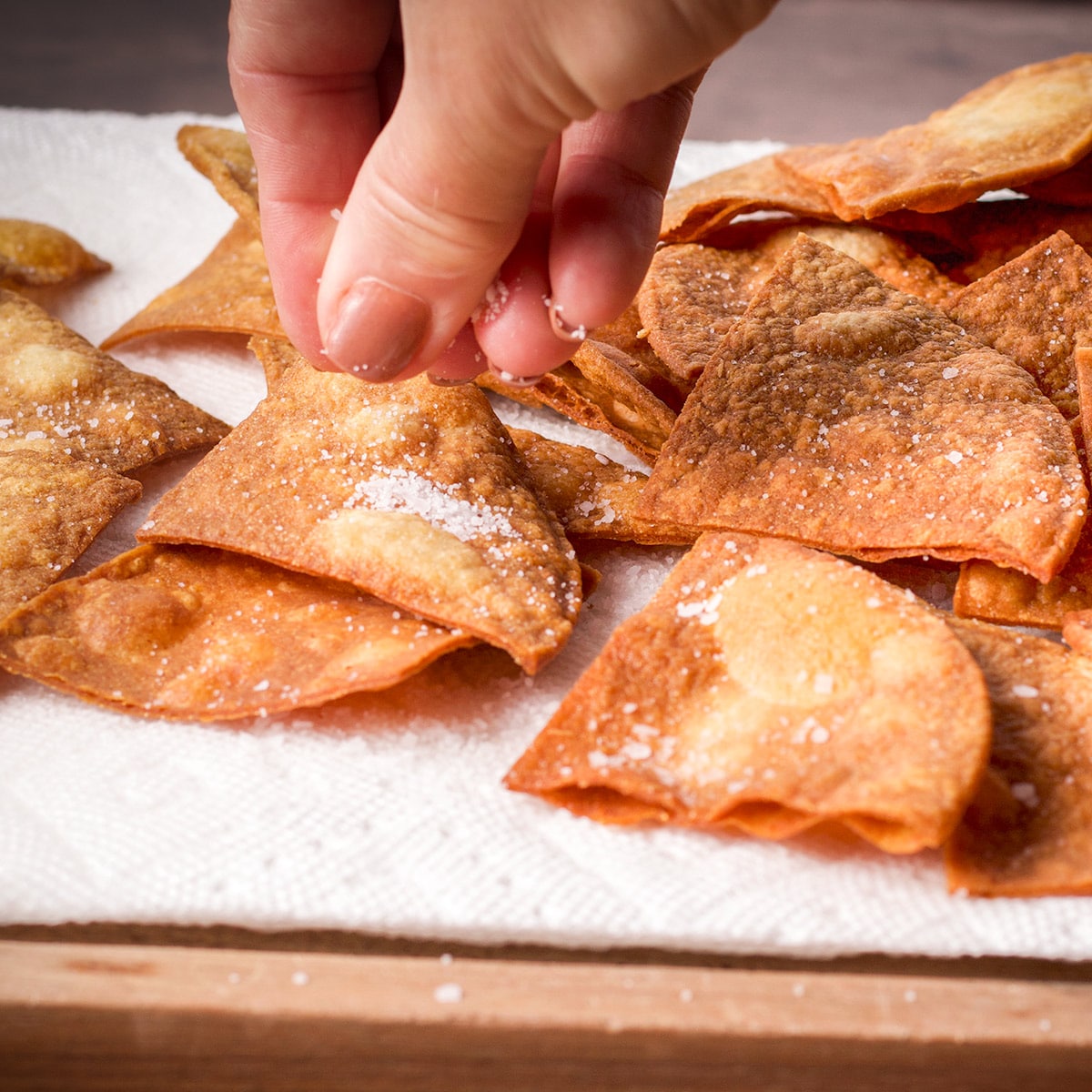 Sprinkle salt over homemade corn tortilla chips immediately after removing them from the hot oil.
