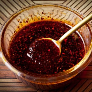 A small glass bowl filled with Aleppo pepper oil.